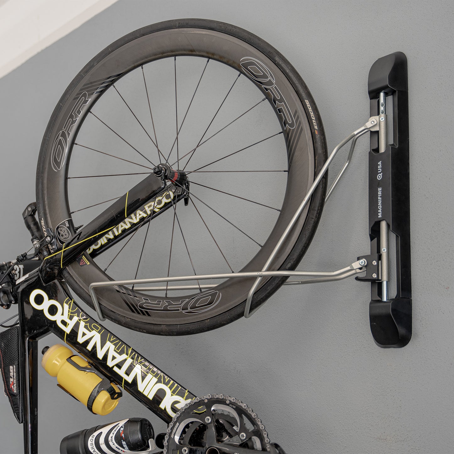 Bike Rack in garage space with bike mounted to wall close up of hardware